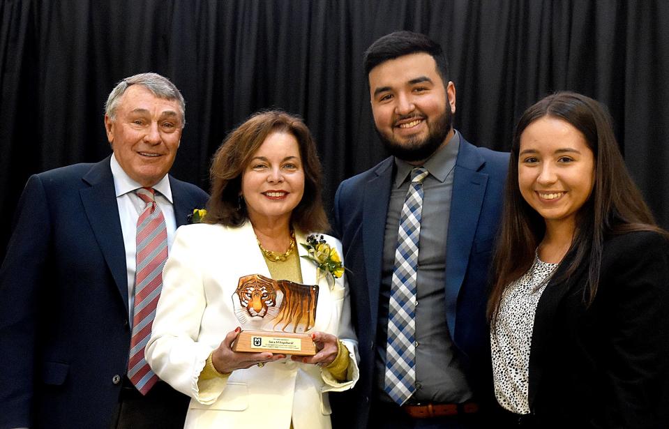 Irl and Sue Engelhardt, left, are presented with a crystal tiger from Robert J. Trulaske S. College of Business students Orlando Guerrero and Mercedes Moravec following President Mun Choi’s announcement of a $1.8 million donation from the Engelhardts to the Heartland Scholars Academy at the Robert J. Trulaske Sr. College of Business on Friday at Cornell Hall.