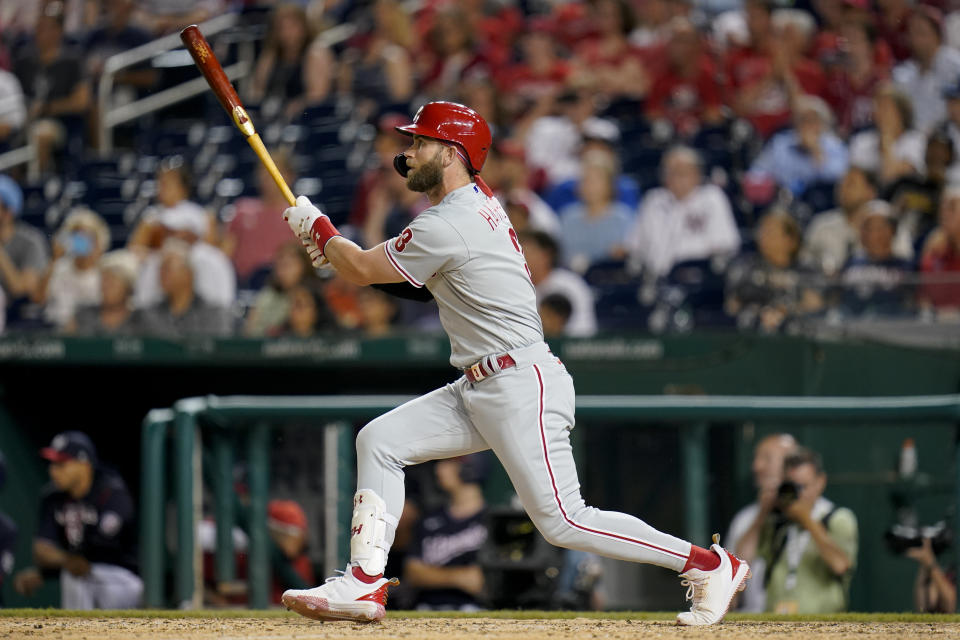 Philadelphia Phillies' Bryce Harper doubles in the eighth inning of the second game of a baseball doubleheader against the Washington Nationals, Friday, June 17, 2022, in Washington. J.T. Realmuto and Kyle Schwarber scored on the play, and Philadelphia won 8-7 in 10 innings. (AP Photo/Patrick Semansky)