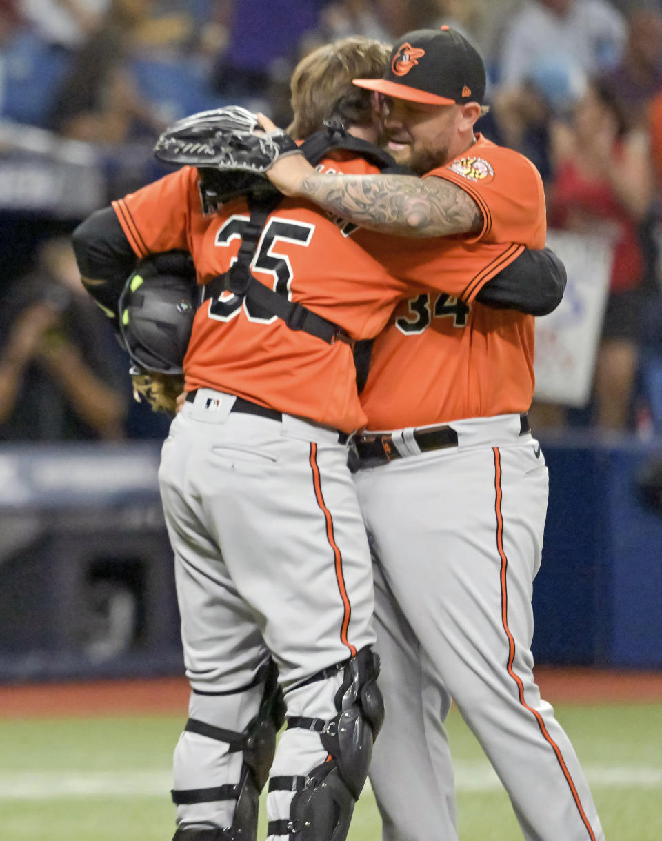 Baltimore Orioles catcher Adley Rutschman (35) hugs reliever Joey Krehbiel after beating the Tampa Bay Rays 6-4 in 11 innings Saturday, July 16, 2022, in St. Petersburg, Fla. (AP Photo/Steve Nesius)