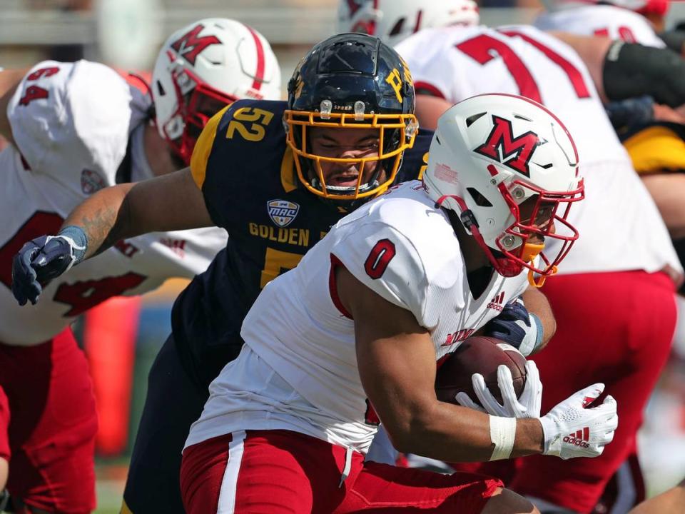 Kent State Golden Flashes defensive lineman John Jackson (52) brings down Miami (Oh) Redhawks running back Rashad Amos (0) during the first half of an NCAA football game at Dix Stadium, Saturday, Sept. 30, 2023, in Kent, Ohio. Jeff Lange/Jeff Lange / USA TODAY NETWORK