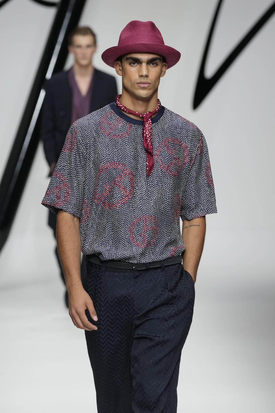 A model wears a creation as part of the Giorgio Armani men's Spring Summer 2024 collection presented in Milan, Italy, Monday, June 19, 2023. (AP Photo/Luca Bruno)