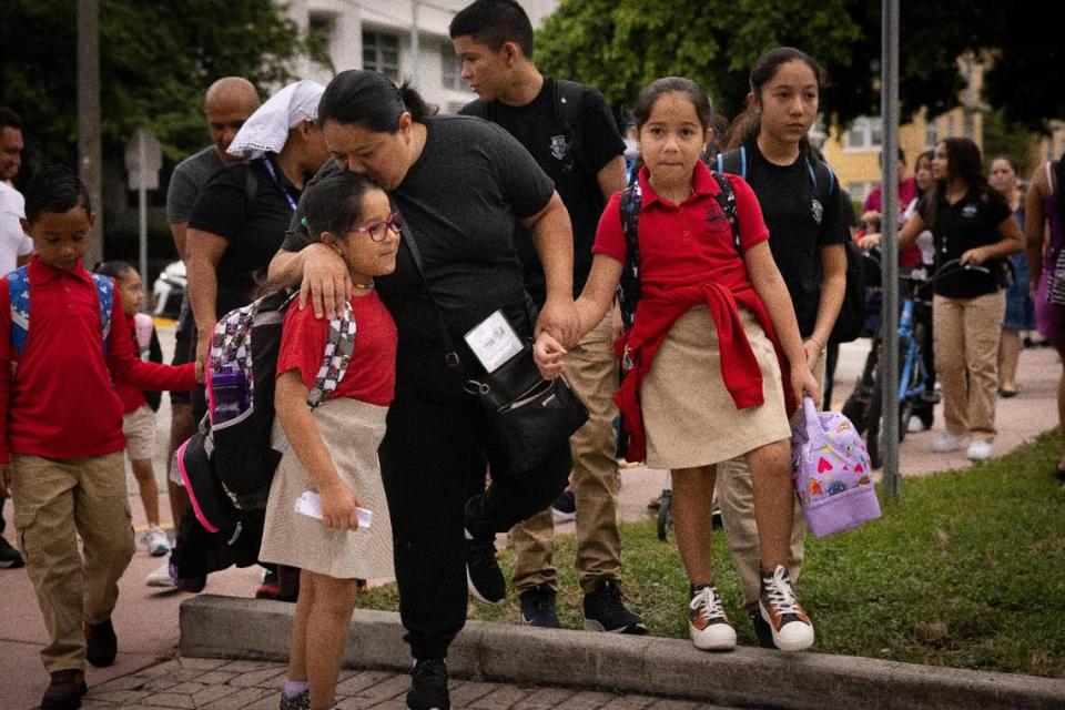 Lillian Avila, center, drops off her kids before the first day of school on Thursday, Aug. 17, 2023, at Fienberg Fisher K-8 Center in Miami Beach.