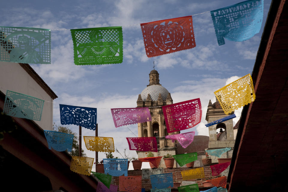 Colorful tissue flags fly near cathedral.