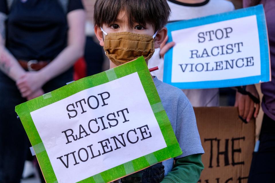 A boy takes part in a rally in a rally to raise awareness of anti-Asian violence, at the Japanese American National Museum in Little Tokyo in Los Angeles, California, on March 13, 2021.