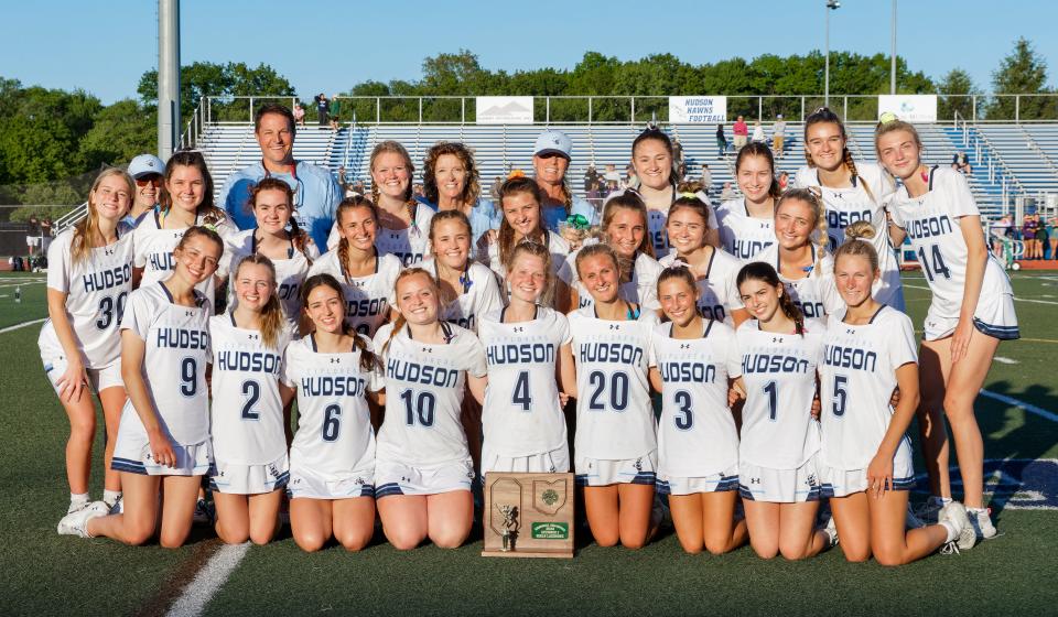 Members of the Hudson girls lacrosse team pose for a photo after defeating Cleveland St. Joseph Academy in a Division I regional final Friday night in Hudson.