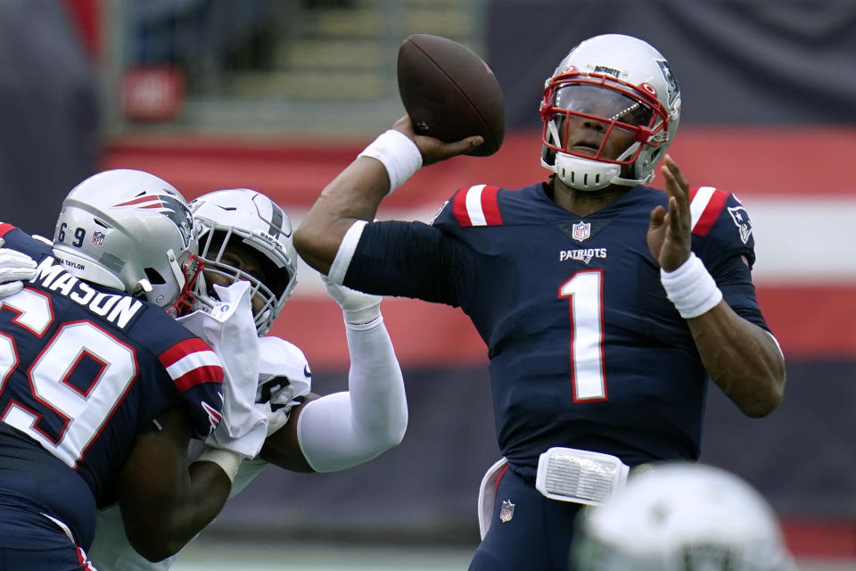 New England Patriots quarterback Cam Newton (1) passes under pressure in the first half of an NFL football game against the Las Vegas Raiders, Sunday, Sept. 27, 2020, in Foxborough, Mass. (AP Photo/Charles Krupa)