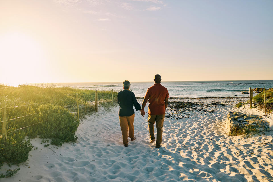 Joyful African-American Couple Experiencing Carefree Moments on Coastal Walk
