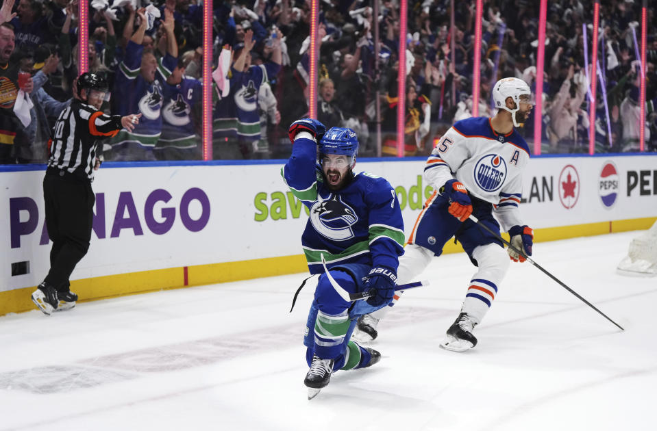 Vancouver Canucks' Conor Garland, left, celebrates his goal as Edmonton Oilers' Darnell Nurse reacts during the third period of Game 1 of a second-round NHL hockey Stanley Cup playoffs series, Wednesday, May 8, 2024, in Vancouver, British Columbia. (Darryl Dyck/The Canadian Press via AP)