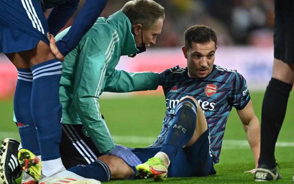  Arsenal's German-born Portuguese defender Cedric Soares (R) receives medical attention before having to leave the game injured during the English League Cup semi-final first leg football match between Liverpool and Arsenal at Anfield in Liverpool - AFP