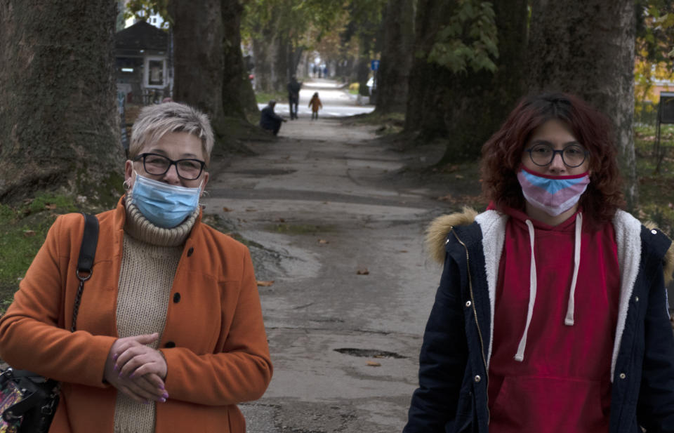 Edisa Sehic, left, walk with her daughter Anisa in Maglaj, central Bosnia, Wednesday, Nov. 18, 2020. In recent years, Edisa Sehic and Janko Samoukovic have often jointly visited schools, town halls and other public venues throughout their still ethnically fragmented homeland to talk about the futility of war from first-hand experience. In 1995, when the Dayton peace agreement ended the war, Sehic was a soldier with the Bosnian government's army and Samoukovic fought with Bosnian Serb troops. (AP Photo/Almir Alic)
