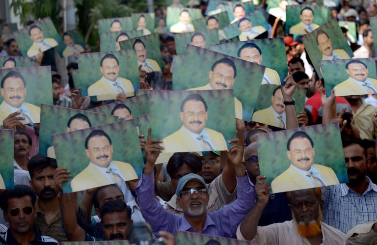 Altaf Hussain (pictured on signs) was arrested in June 2014 by British police on suspicion of money laundering charges, but later released on bail