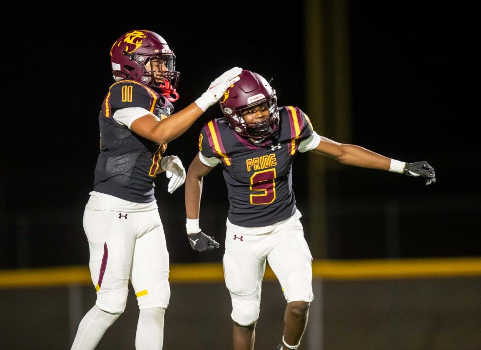 Sep 29, 2023; Phoenix, AZ, USA; Mountain Pointe Pride Chase Shumate (11) pats wide receiver Anthony ColemanÕs (9) helmet in celebration at Mountain Pointe High SchoolÕs football field in Phoenix on Sept. 29, 2023.