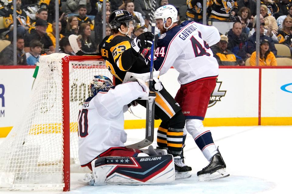 Columbus Blue Jackets' Vladislav Gavrikov (44) checks Pittsburgh Penguins' Teddy Blueger (53) onto Blue Jackets goaltender Elvis Merzlikins (90) during the second period of an NHL hockey game in Pittsburgh, Friday, April 29, 2022. (AP Photo/Gene J. Puskar)