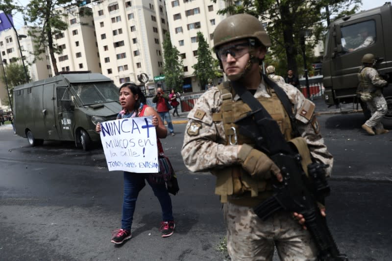 Demonstrator holds a sign during a protest against the increase in the subway ticket prices in Santiago