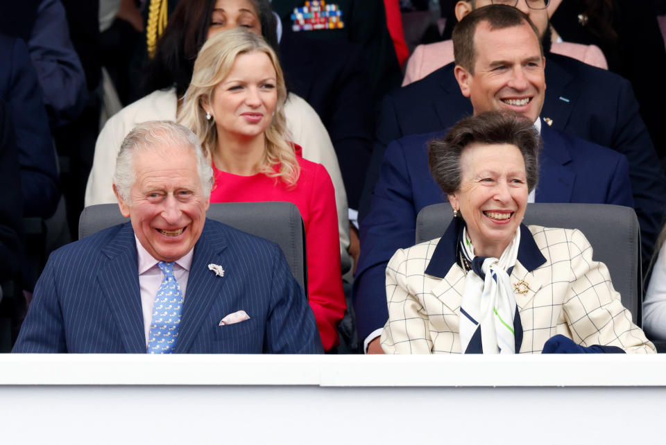 King Charles III and Princess Anne laugh as they sit next to each other. (Getty Images)