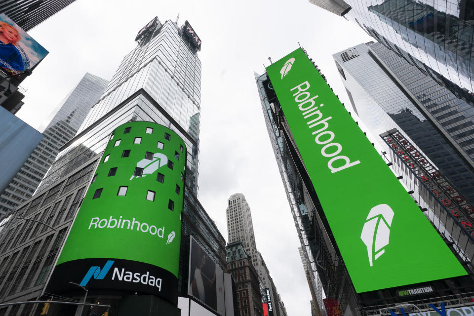 FILE - Electronic screens in New York's Times Square announce Robinhood's IPO on July 29, 2021.  Robinhood Markets Inc. has received a notice from the Securities and Exchange Commission regarding alleged securities violations in its crypto division.  The company said in a regulatory filing that it has received investigative subpoenas from the SEC on issues such as cryptocurrency listings, cryptocurrency custody and platform operations.  (AP Photo/Mark Lennihan, File)