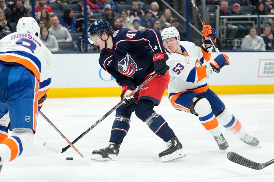 Mar 24, 2023; Columbus, Ohio, USA;  Columbus Blue Jackets center Hunter McKown (41) skates past New York Islanders center Casey Cizikas (53) during the third period of the NHL hockey game at Nationwide Arena. The Blue Jackets won 5-4 in overtime. Mandatory Credit: Adam Cairns-The Columbus Dispatch