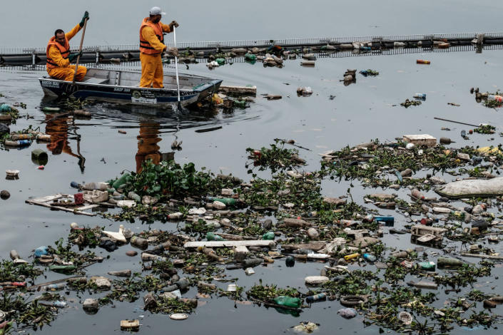 <p>View of floating debris carried by the tide and caught by the “eco-barrier” before entering Guanabara Bay, at the mouth of Meriti river in Duque de Caxias, next to Rio de Janeiro, Brazil, on July 20, 2016. (Yasuyoshi Chiba/AFP/Getty Images)