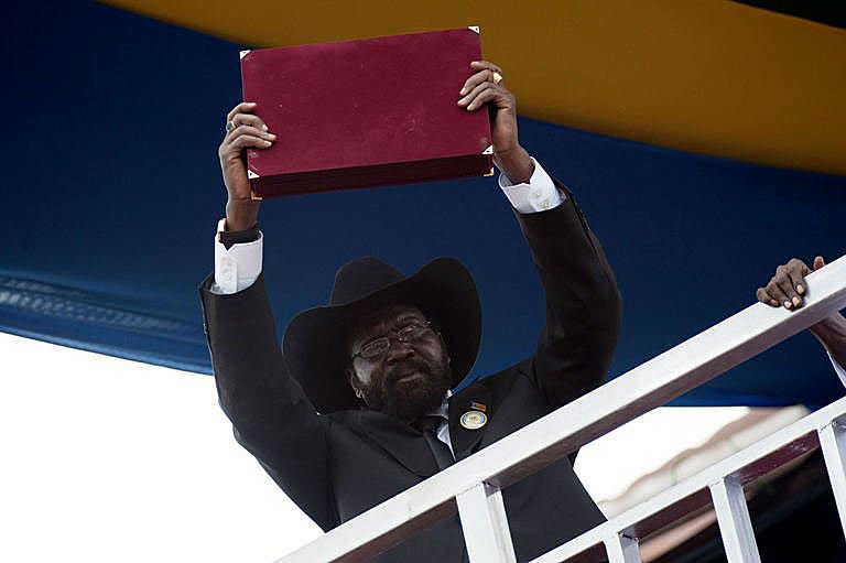 South Sudan's President Salva Kiir shows the crowd the signed constitution of their new nation during celebrations marking South Sudan's independence in Juba. Celebrations erupted in South Sudan on Saturday as the world's newest nation proclaimed formal independence and turned the page on five decades of devastating conflict with the north