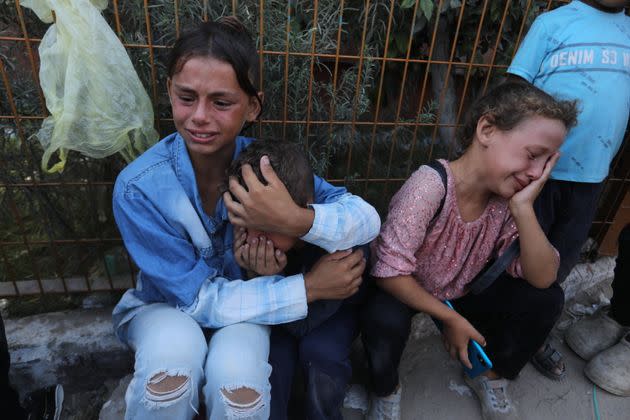 Palestinian children grieve for relatives who were killed in Israeli air strikes in Khan Younis, Sept. 3.