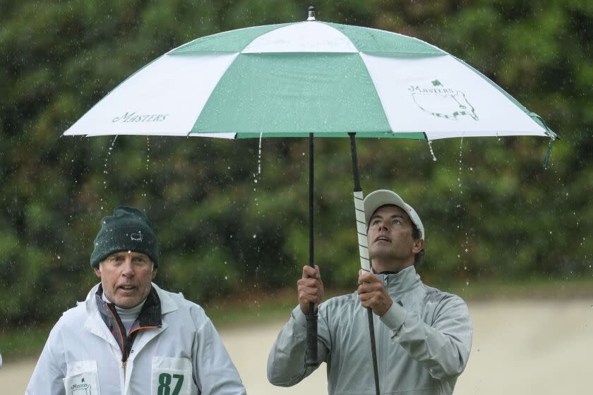 Adam Scott, of Australia, walks off the 13th green during the weather delayed third round of the Masters golf tournament at Augusta National Golf Club on Saturday, April 8, 2023, in Augusta, Ga. (AP Photo/Mark Baker)