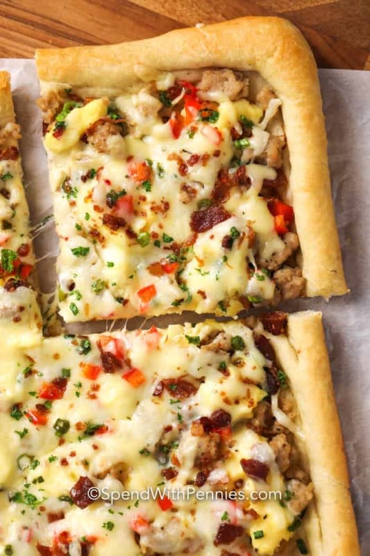 <p>Spend With Pennies</p><p>This pizza is piled high with our favorite breakfast toppings including sausage, bacon, green onions, eggs and of course heaps of cheese. Consider the best grab-and-go breakfast that will bring everyone to the table!</p><p><strong>Get the recipe: <a href="https://www.spendwithpennies.com/cheesy-breakfast-pizza/" rel="nofollow noopener" target="_blank" data-ylk="slk:Cheesy Breakfast Pizza;elm:context_link;itc:0;sec:content-canvas" class="link rapid-noclick-resp">Cheesy Breakfast Pizza</a></strong></p>
