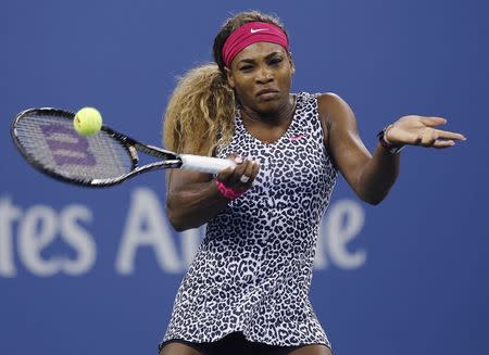 Serena Williams of the U.S. returns a shot to compatriot Taylor Townsend during their women's singles match at the U.S. Open tennis tournament in New York, August 26, 2014. REUTERS/Shannon Stapleton