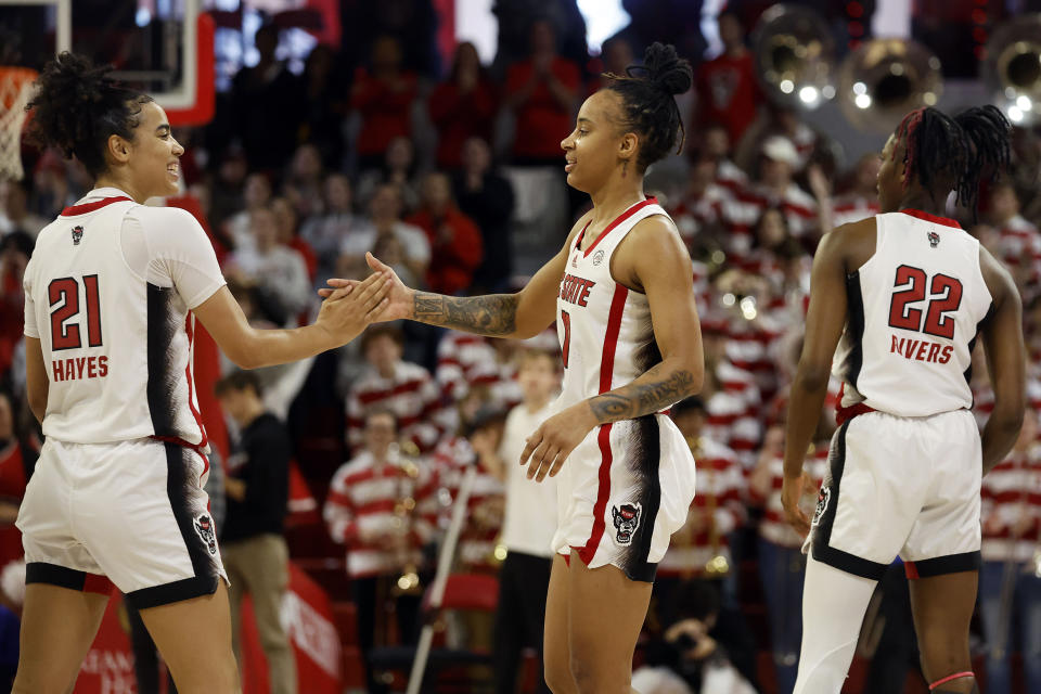 North Carolina State's Madison Hayes (21) and Aziaha James, center, celebrate following their win over Duke following an NCAA college basketball game, Sunday, Jan. 21, 2024, in Raleigh, N.C. (AP Photo/Karl B. DeBlaker)