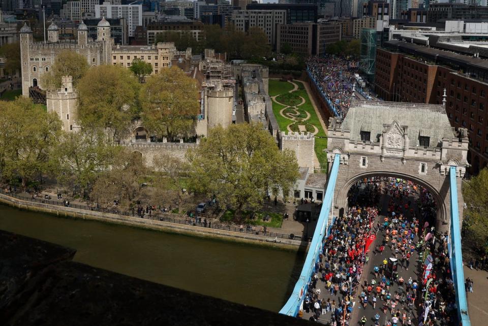 Runners pass the halfway mark of the 2024 London Marathon at Tower Bridge (Peter Cziborra / Reuters)