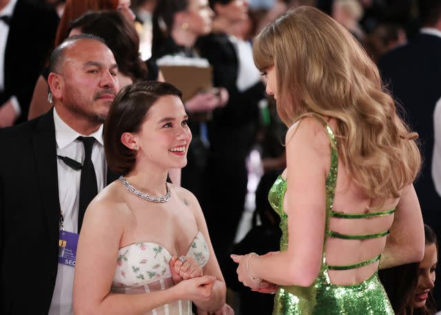 Taylor Swift Holds Court in Green Gucci Dress at Golden Globes 2024