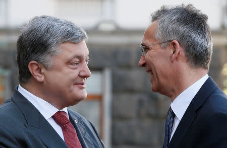 Ukrainian President Petro Poroshenko greets NATO Secretary General Jens Stoltenberg before a meeting in Kiev, Ukraine, July 10, 2017. REUTERS/Valentyn Ogirenko