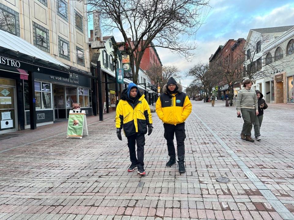 Two security guards walk down the Church Street Marketplace in Burlington, Vt., on Dec. 6, 2023. The city has strengthened security to help shoppers feel safe this holiday season amid concerns about drug activity, gun violence and retail theft.