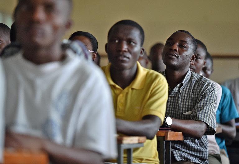 Serge Claver Nzisabira (R) attends a class at Burundi University in Bujumbura