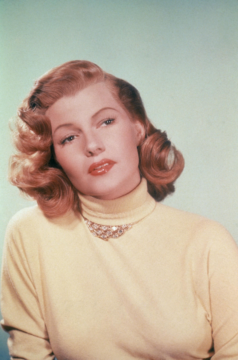 The actress wears a yellow turtleneck, circa 1950.&nbsp;