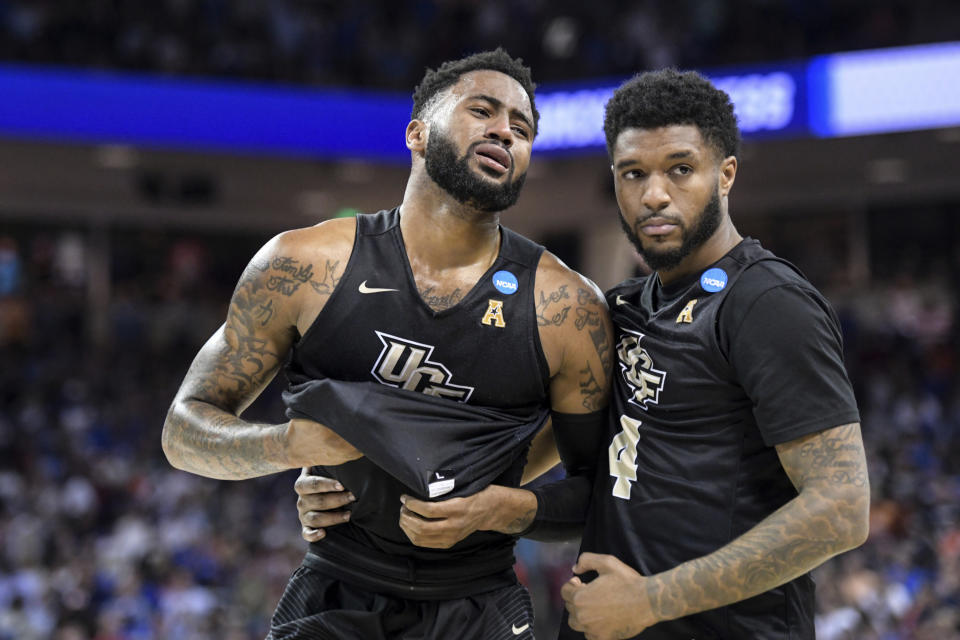Central Florida guard Dayon Griffin, left, is comforted by Ceasar DeJesus (4) after a second-round game against Duke in the NCAA men's college basketball tournament Sunday, March 24, 2019, in Columbia, S.C. Duke won 77-76. (AP Photo/Sean Rayford)