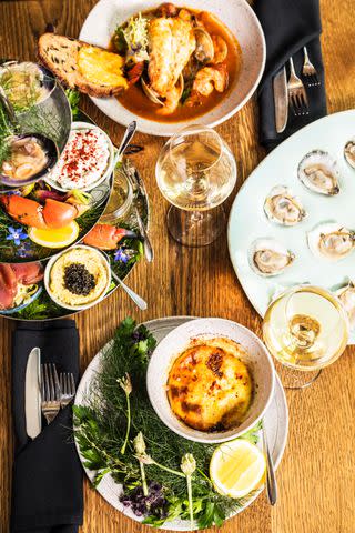 <p> LISA CORSON</p> The Seasonal Seafood Tower and Eastern Cioppino at Seabird feature North Carolina shellfish.