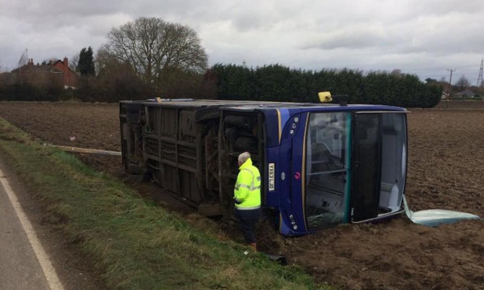 A double decker bus blown on to its side by Storm Doris near Wisbech, Cambridgeshire