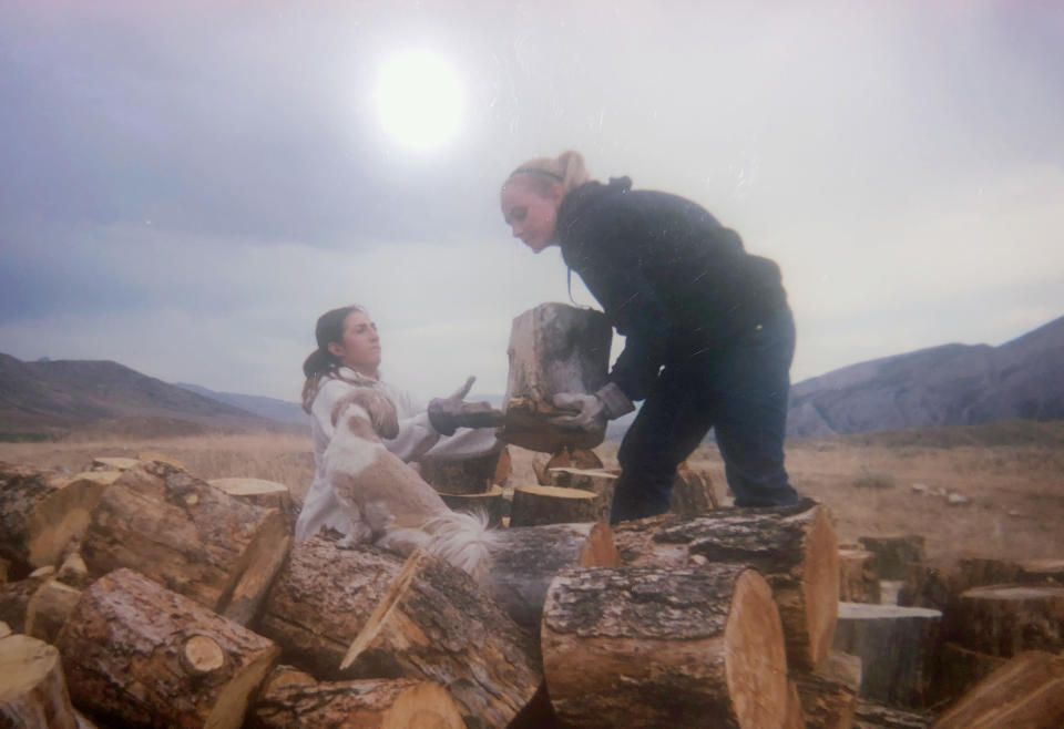 Sophia Boutrous, left, and Kelsie VanMeveren lift lumber at Trinity Teen Solutions in 2011. According to former residents, girls at the ranch were given film cameras and allowed to take photos, but Trinity Teen Solutions had discretion over which images were given back to them. (Courtesy Kelsie VanMeveren)