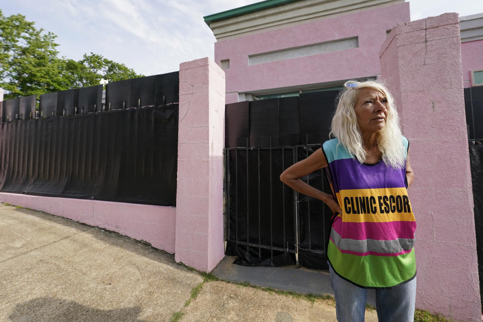 FILE - Derenda Hancock, co-organizer of the "Pinkhouse Defenders," a group of volunteers that shield and escort patients entering the Jackson Women's Health Organization (JWHO), Mississippi's last remaining abortion clinic, called the "Pinkhouse," stands watch on May 3, 2022. There is a case before the U.S. Supreme Court involving the state's ban on most abortions after the 15th week. But it could result in a reversal of Roe v. Wade. A leaked draft of a court opinion shows a conservative majority ready to topple the court's 1973 decision that established a nationwide right to abortion. (AP Photo/Rogelio V. Solis, File)
