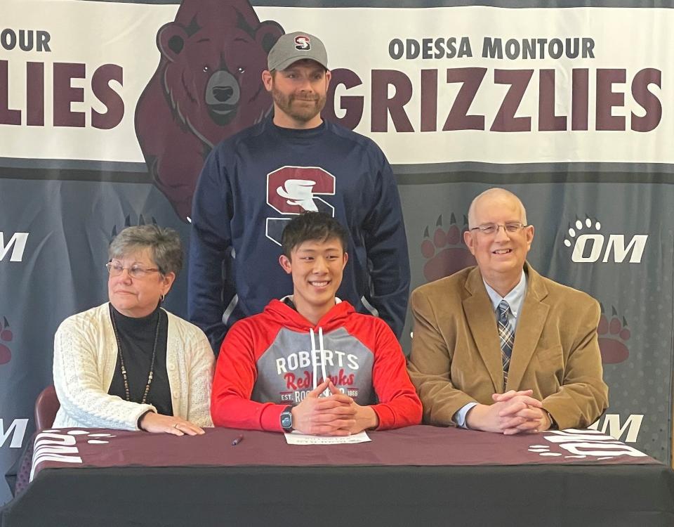 Odessa-Montour senior Jon Spencer, front center, during a signing celebration at O-M on March 9, 2023