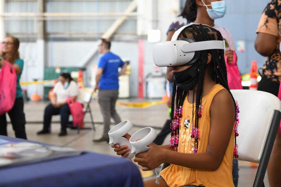 A Girl Scout practices flying through virtual reality flight simulation at Aviation Day in March 2022. The event was hosted by Girl Scouts of Tropical Florida.