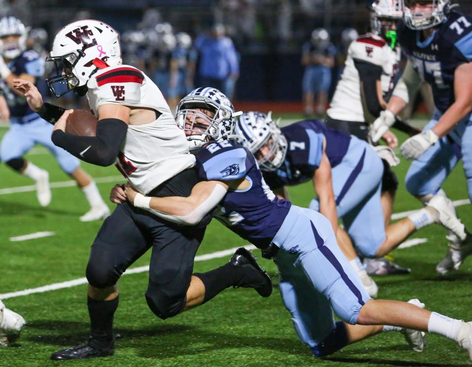 West Essex's Luke Struss runs the ball as West Morris' Jack DeFusco defends during the first half of a football game at West Morris Central High School on November 11, 2022.