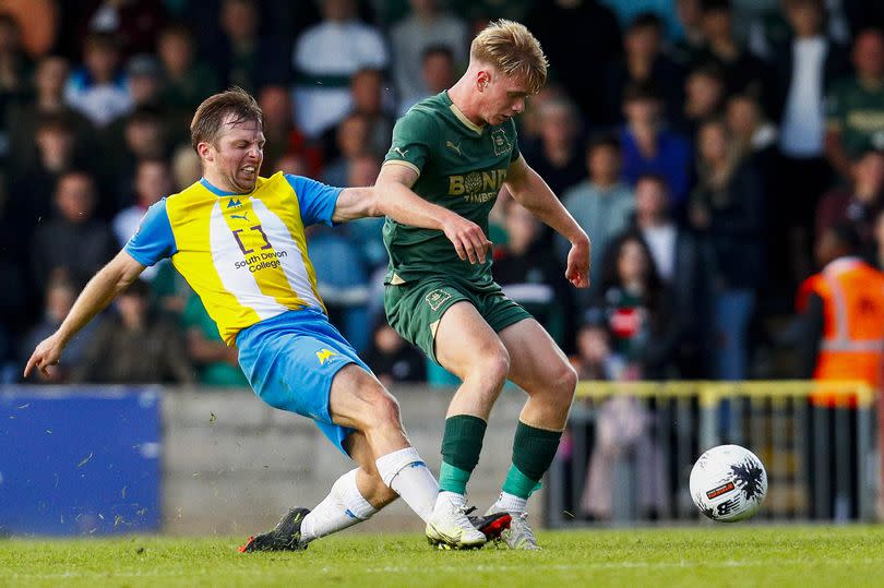 Argyle midfielder Will Jenkins-Davies is tackled by Torquay United's Tom Lapslie during the pre-season game at Plainmoor on Tuesday, July 18, 2023 - Photo: Dave Crawford/PPAUK