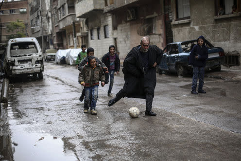 <span class="caption">A game of football in Douma, Syria, where prospects for many youngsters look bleak.</span> <span class="attribution"><a class="link " href="http://www.epa.eu/war-photos/conflicts-general-photos/daily-life-in-rebel-held-douma-photos-52356236" rel="nofollow noopener" target="_blank" data-ylk="slk:EPA Images;elm:context_link;itc:0;sec:content-canvas">EPA Images</a></span>