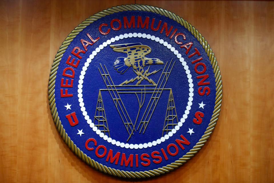 FILE - The seal of the Federal Communications Commission (FCC) is seen before an FCC meeting to vote on net neutrality, Dec. 14, 2017, in Washington. The FCC is announcing that it will outlaw all robocalls featuring AI-generated voices under the existing Telephone Consumer Protection Act. The news comes after celebrities and politicians, including President Joe Biden, have been impersonated using the technology. (AP Photo/Jacquelyn Martin, File)