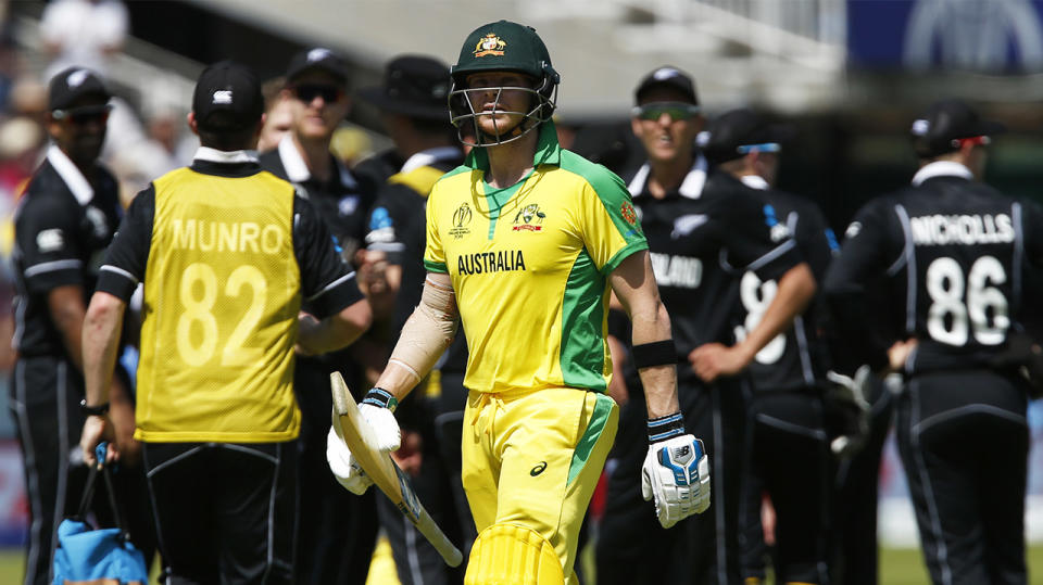 Steve Smith walks off holding his bat in disappointment against New Zealand.