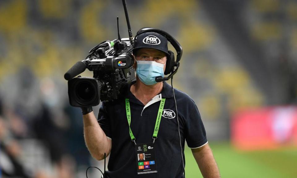 Fox Sports camera man wearing a mask