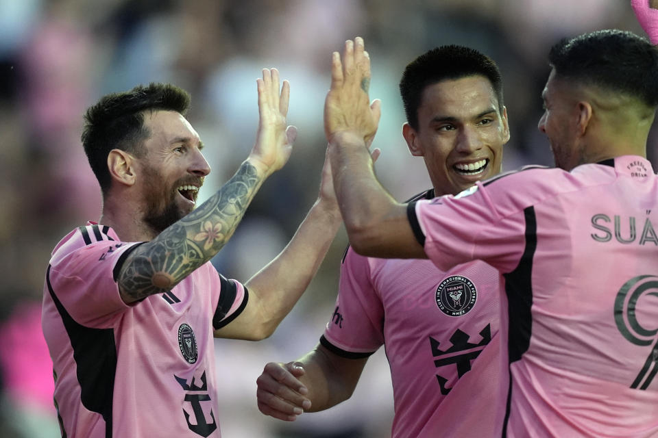 Inter Miami forward Lionel Messi, left, celebrates with Inter Miami midfielder Diego Gomez, center, and Inter Miami forward Luis Suarez (9) after scoring his side's fifth goal during the second half of an MLS soccer match against Orlando City, Saturday, March 2, 2024, in Fort Lauderdale, Fla. (AP Photo/Rebecca Blackwell)