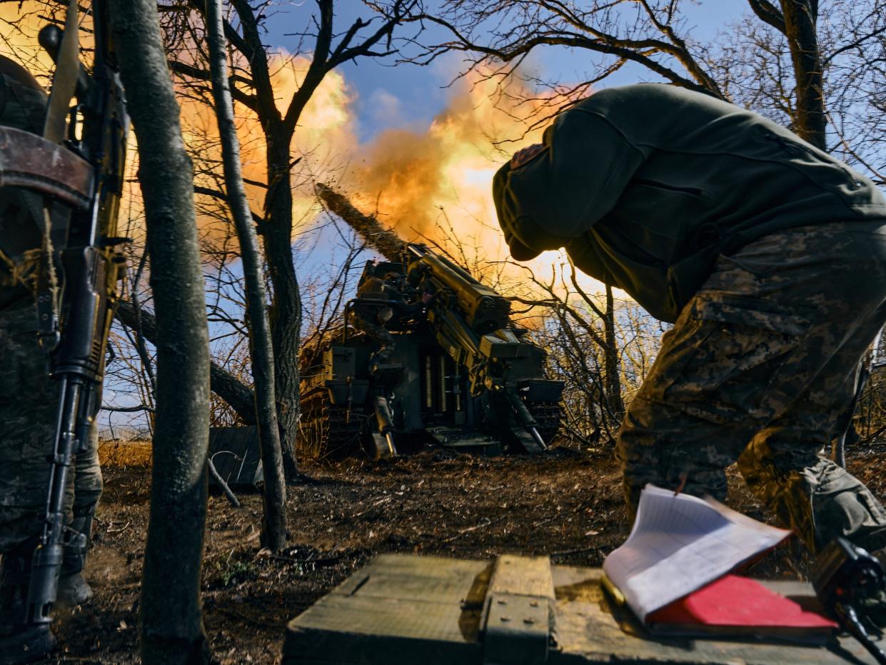 Ukrainian soldiers fire a self-propelled howitzer towards Russian positions near Bakhmut,