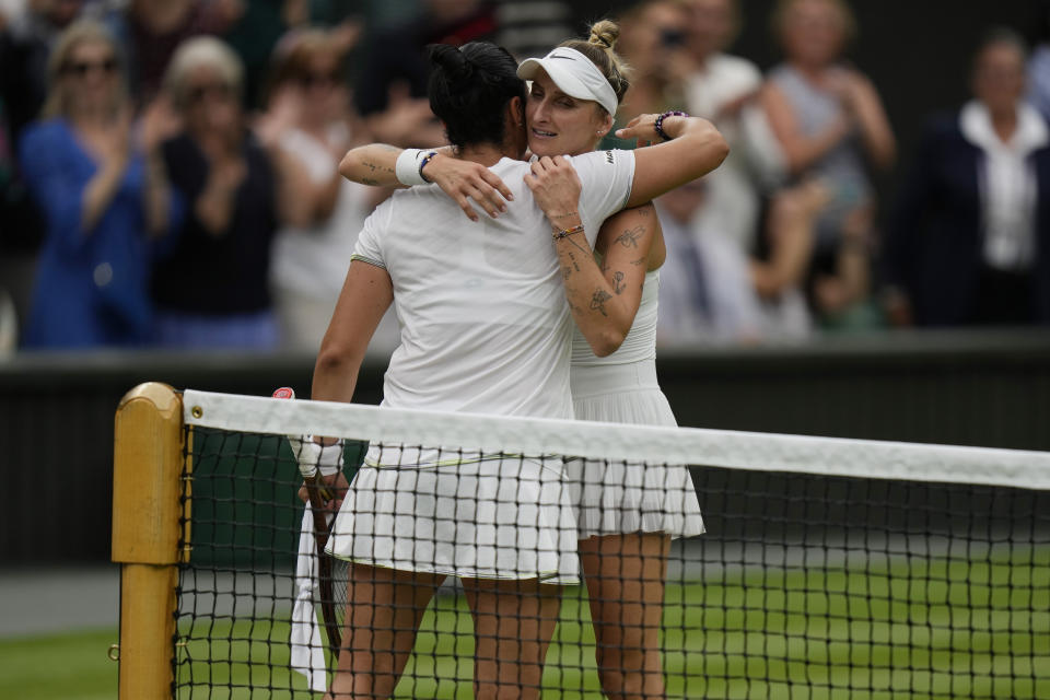 Czech Republic's Marketa Vondrousova, right, embraces Tunisia's Ons Jabeur after beating her in the women's singles final on day thirteen of the Wimbledon tennis championships in London, Saturday, July 15, 2023. (AP Photo/Alastair Grant)